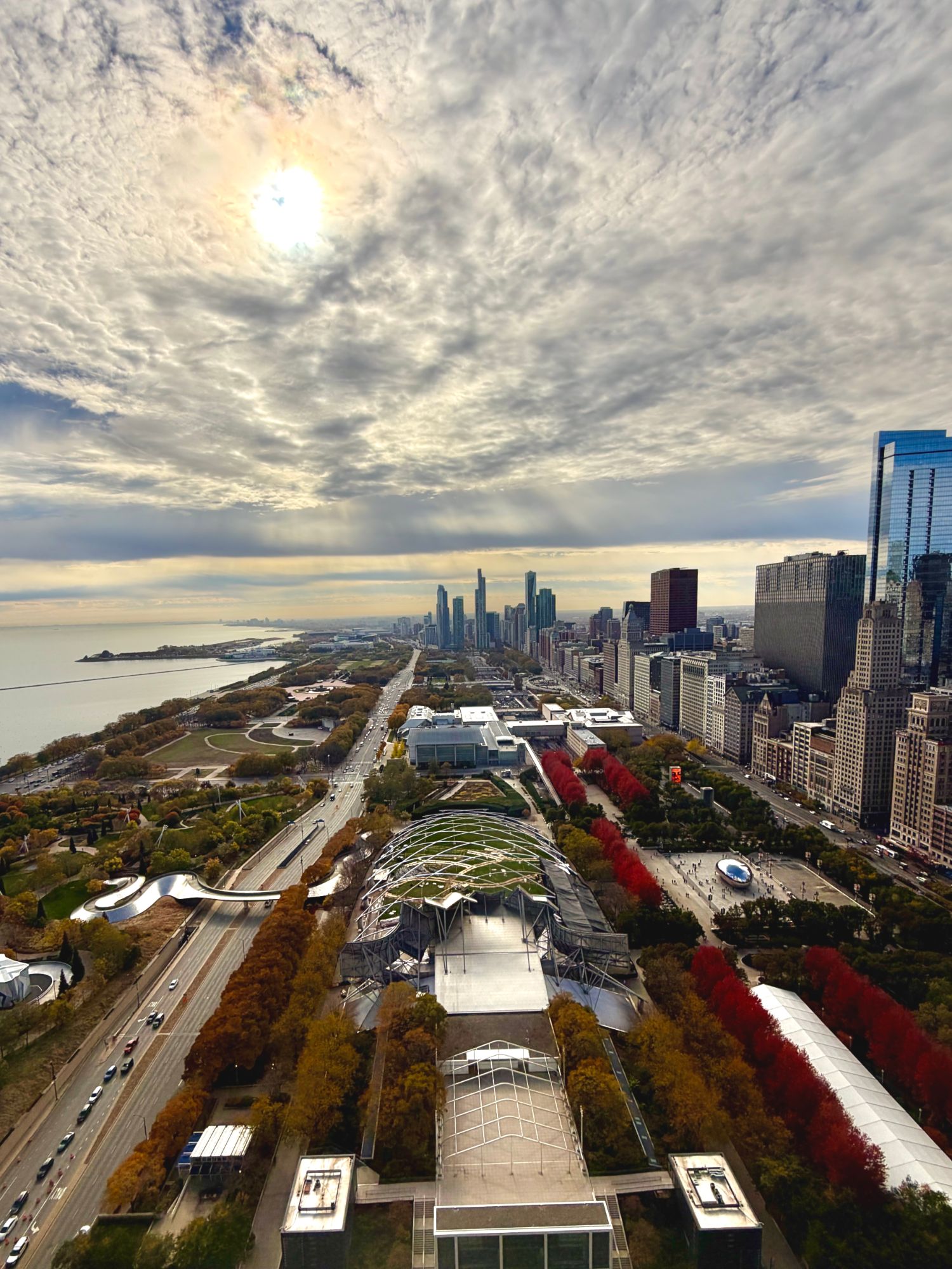 Millennium Park and the Chicago lakefront from above, sun breaking through the clouds